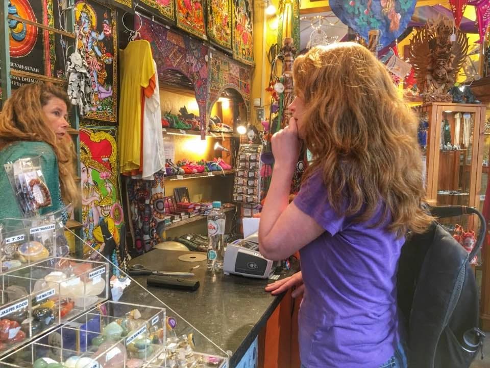 Melissa in a Dutch shop of Indian goods, surrounded by textiles and instruments.