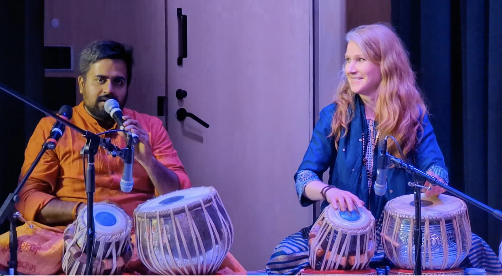 Melissa seated at the tabla beside Satyaprakash Mishra Ji, both mid-lesson.